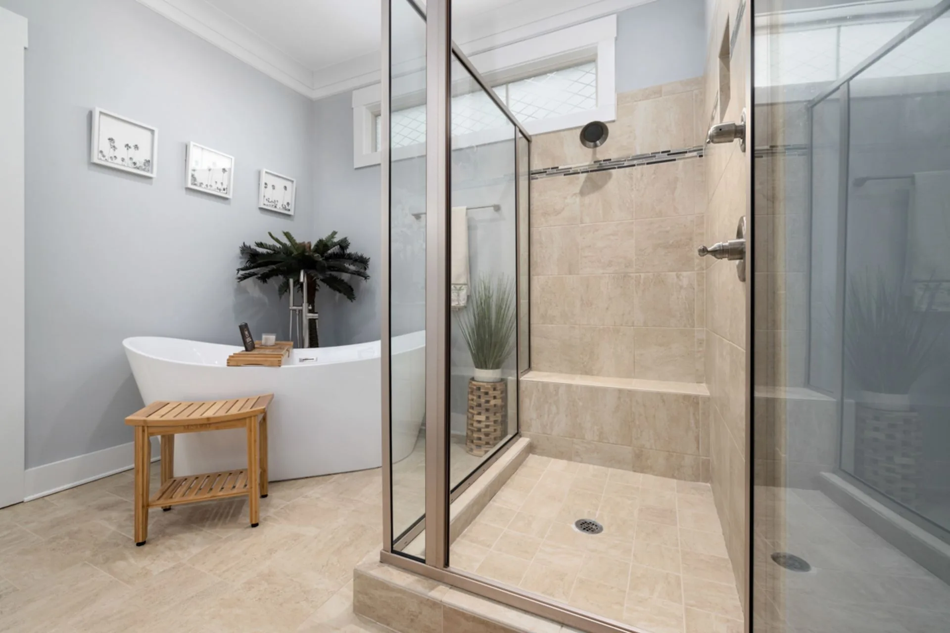 Clean modern bathroom with a bathtub and glass shower enclosure
