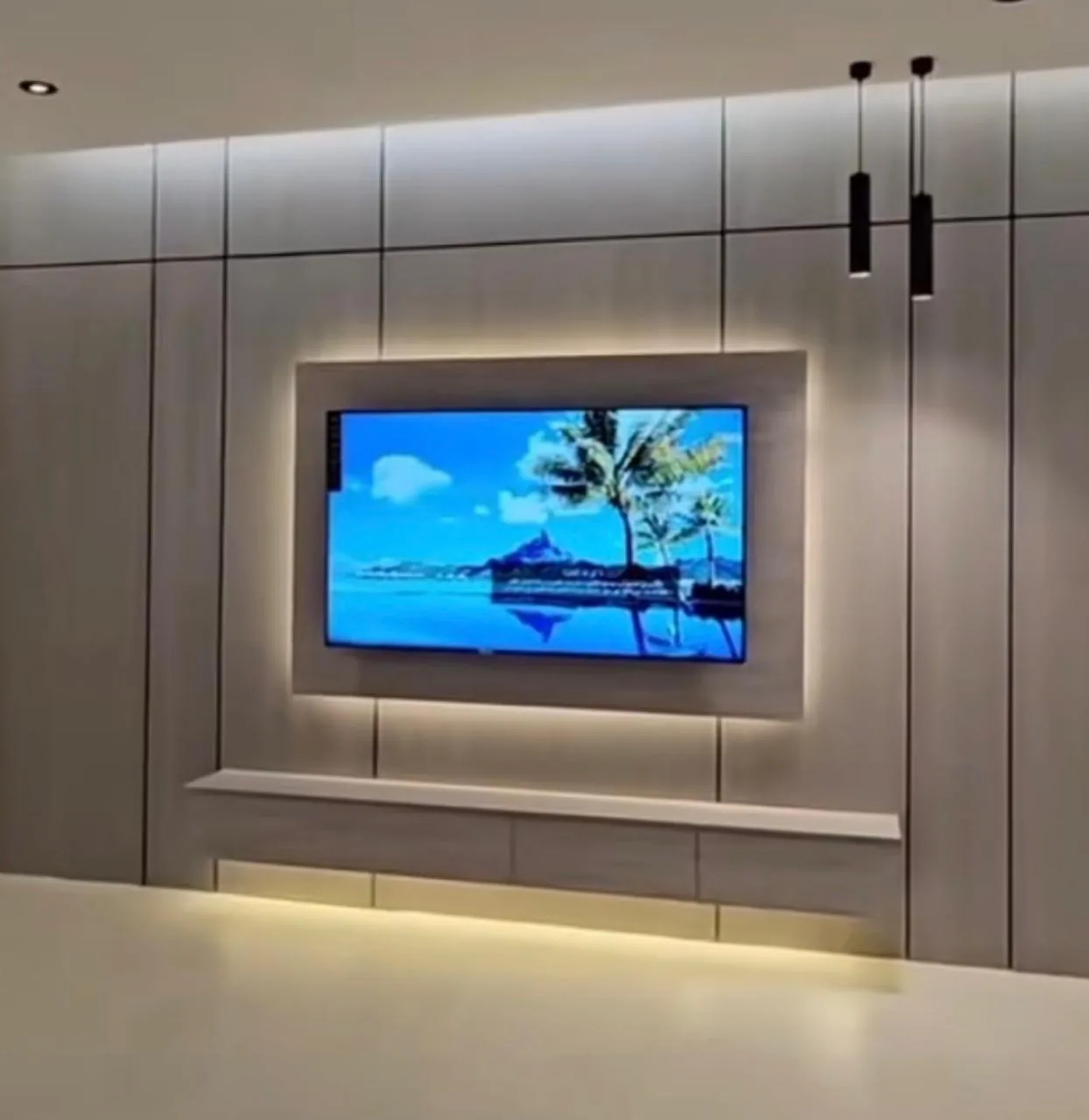 Panelled TV feature wall with a backlit floating frame, LED-lit console and pendant lights, installed by FM Trading
