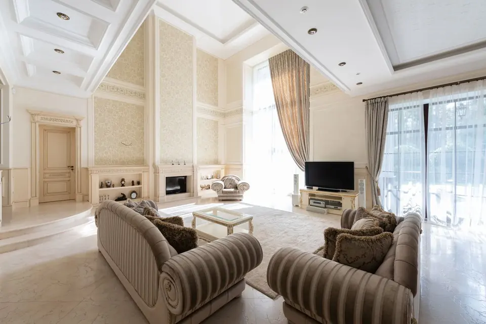 Living room curtains and windows near a TV and sofa setup