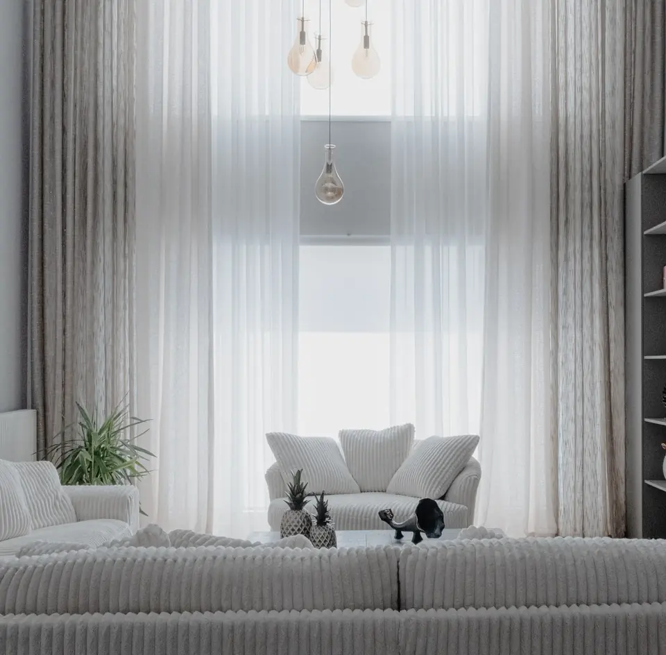 Minimalist white curtains in a bright modern living room