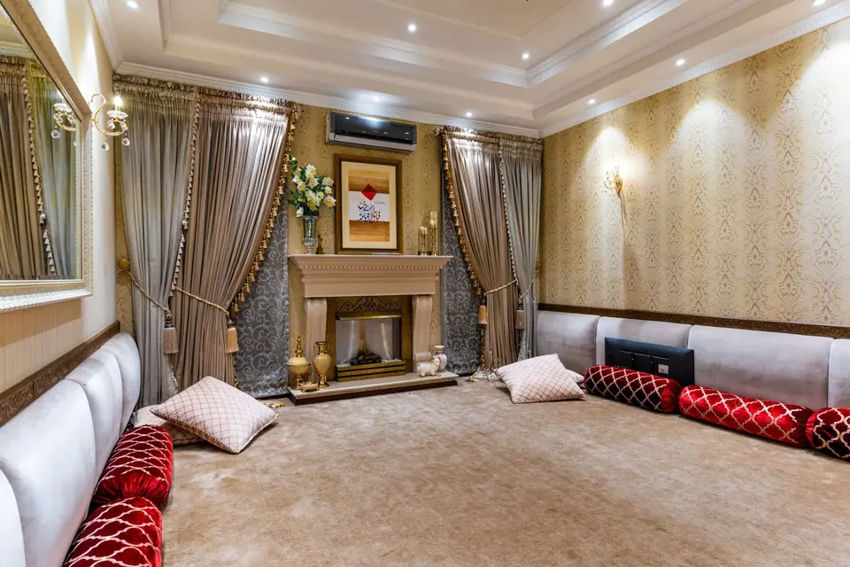 Traditional living room curtains beside an ornate fireplace
