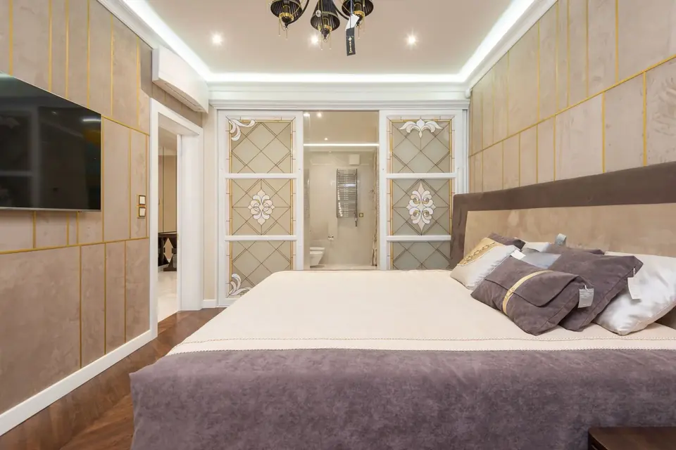 Bright luxury bedroom with sophisticated wallpaper and soft lighting