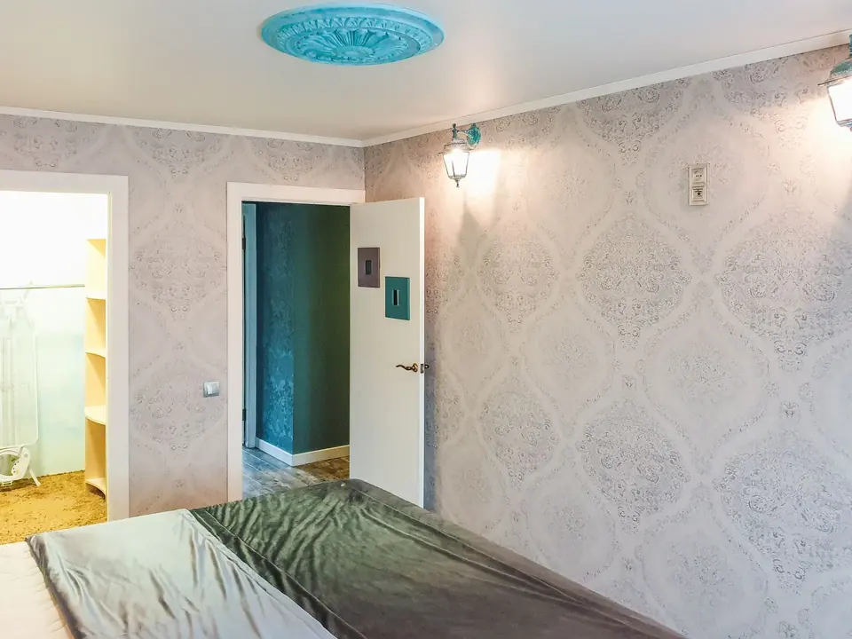 Modern bedroom featuring stylish designer wallpaper and elegant furnishings